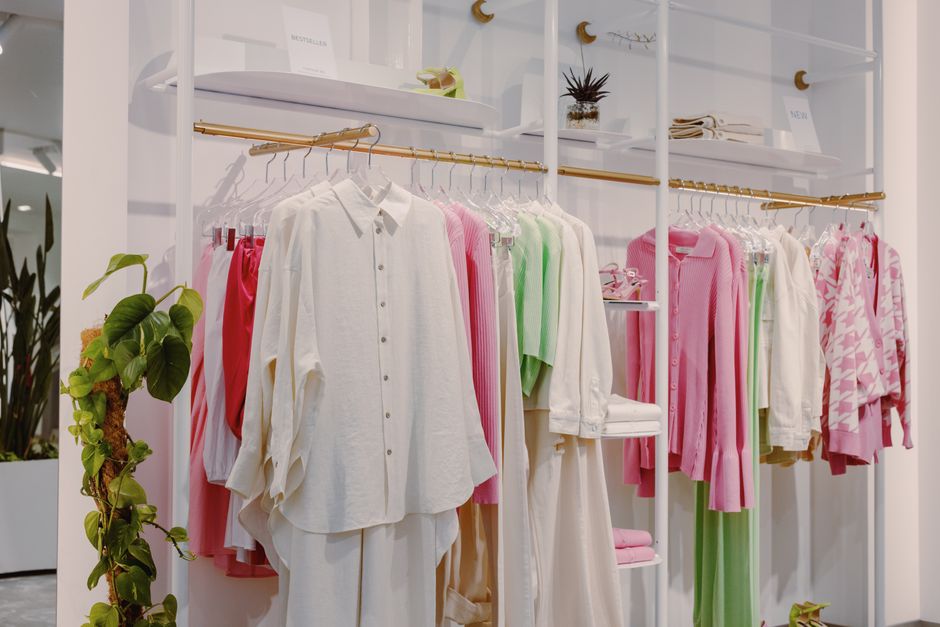 Clothing rack with shirts and blouses inside a boutique