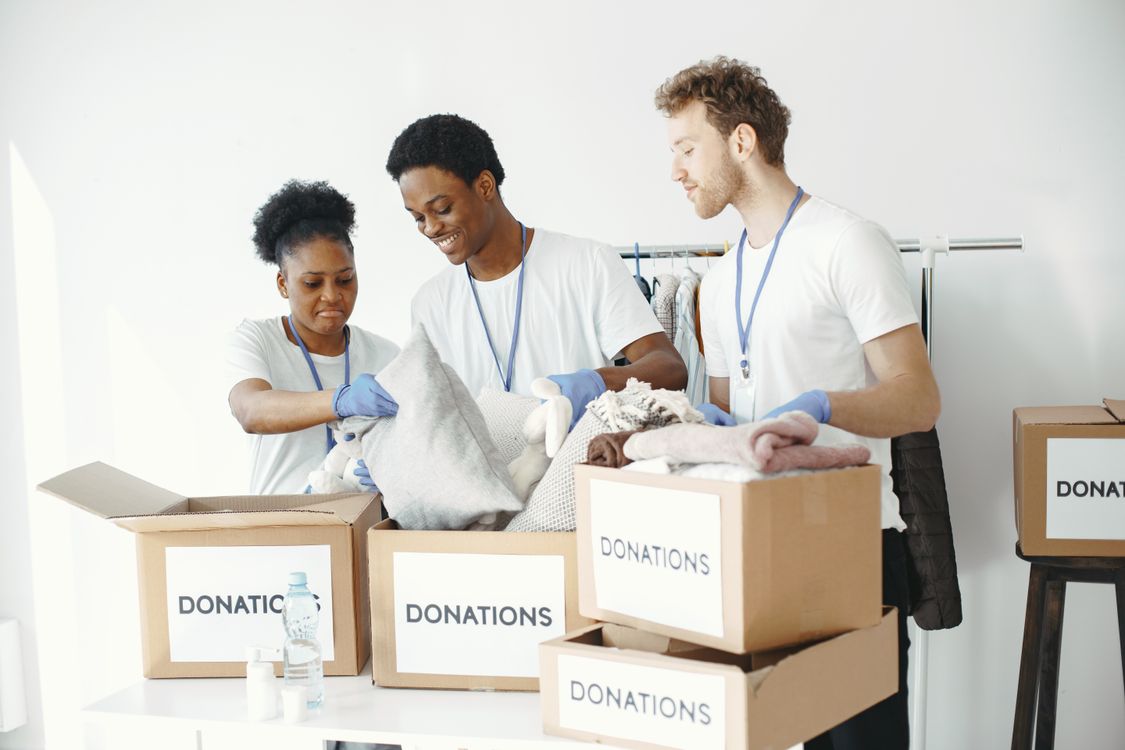Volunteers packing clothing into donation boxes